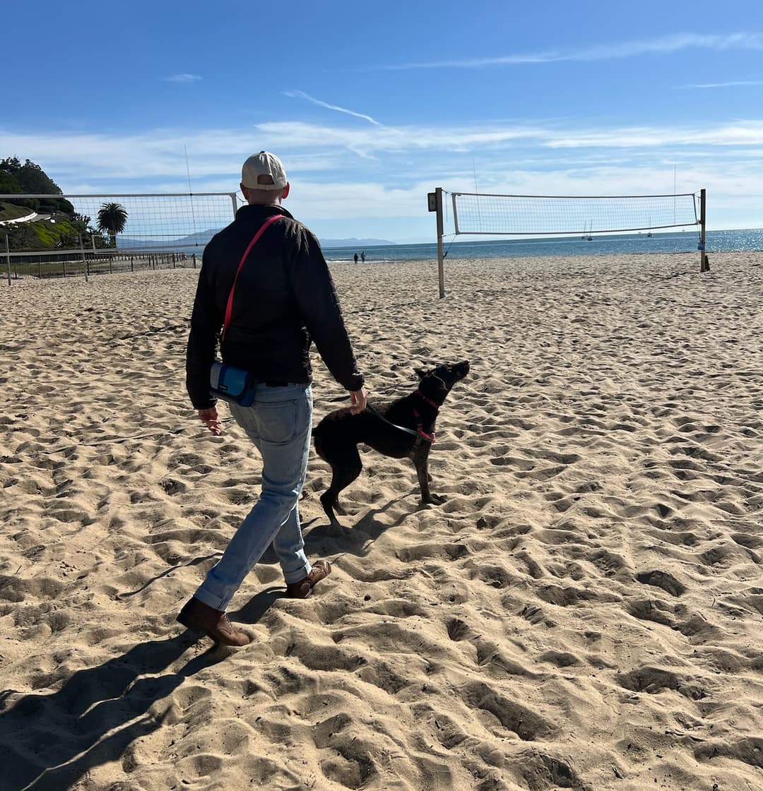 Patrick walking Mara on the beach